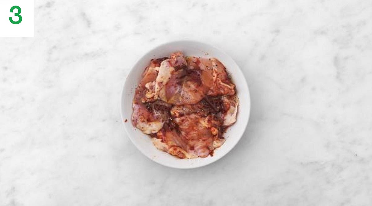 Pop the parcel onto one side of a large baking tray.
Meanwhile, lay the chicken breasts on a large plate.
Season with salt and pepper. Drizzle over the honey and vegan 'nduja (add less if you'd prefer things milder), then rub to coat.