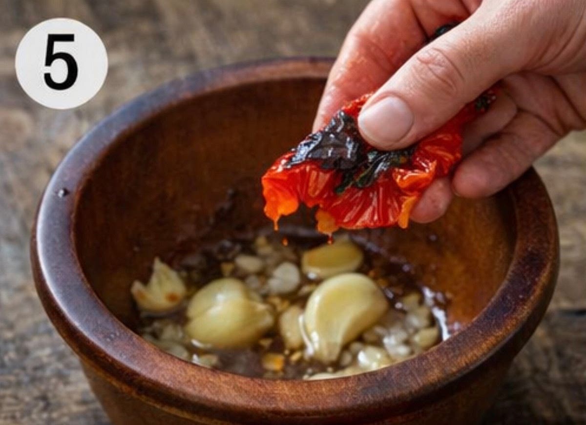 Crush the garlic separately with a little salt until it turns into a paste.