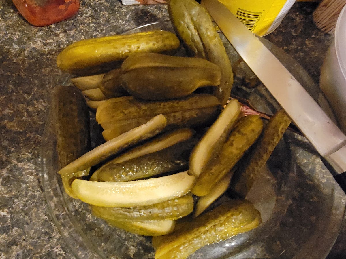 Cut pickles into quarters.