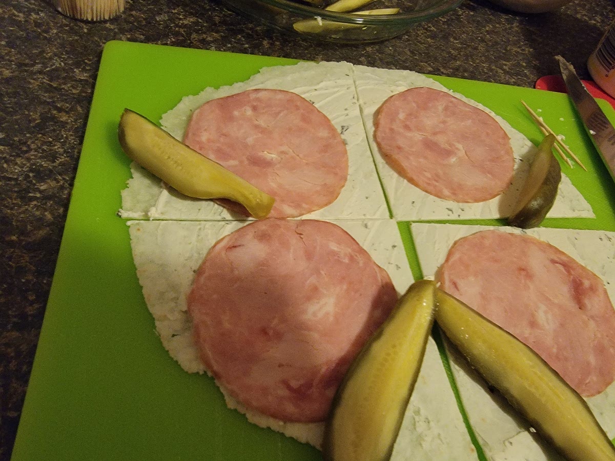 Place a quarter piece of pickle at each edge of the 4 pieces of tortilla next to the meat.