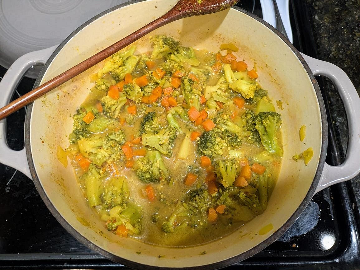Add in the broth, mustard, spices, and (defrosted) broccoli. Cover and bring to a boil over high heat. Reduce heat to medium, and let simmer (covered) for 10 minutes