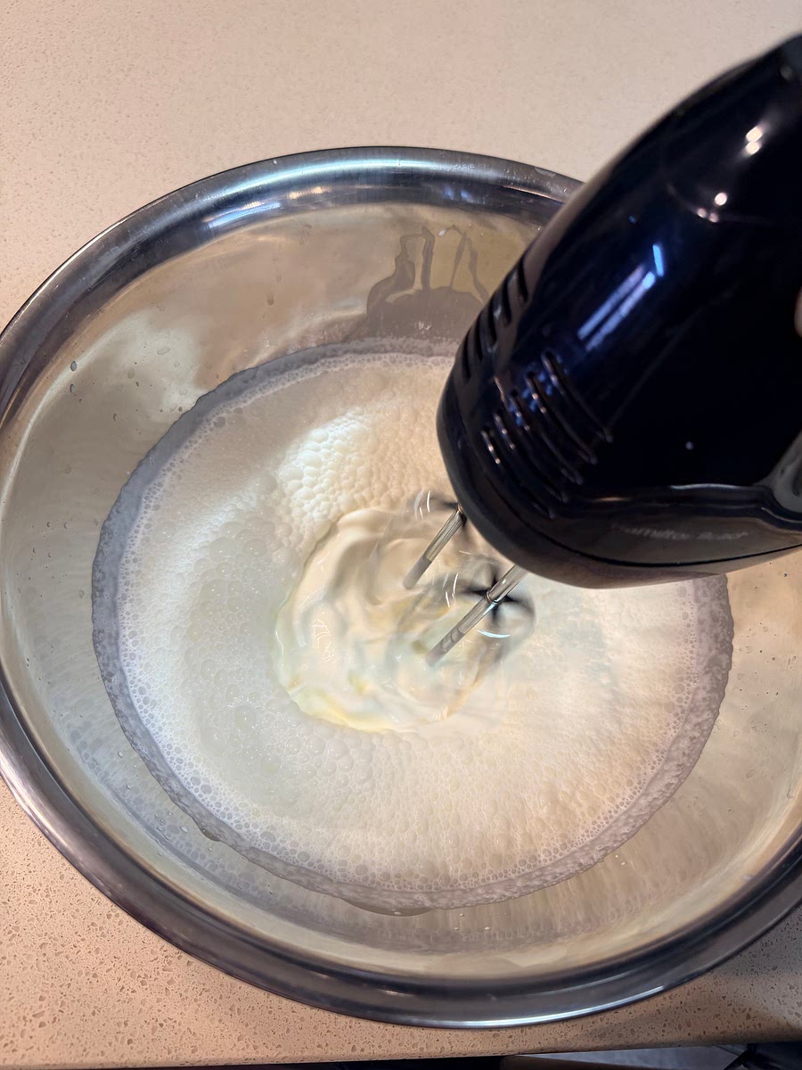 In a large bowl, use an electric mixer to whip the heavy cream until stiff peaks form.