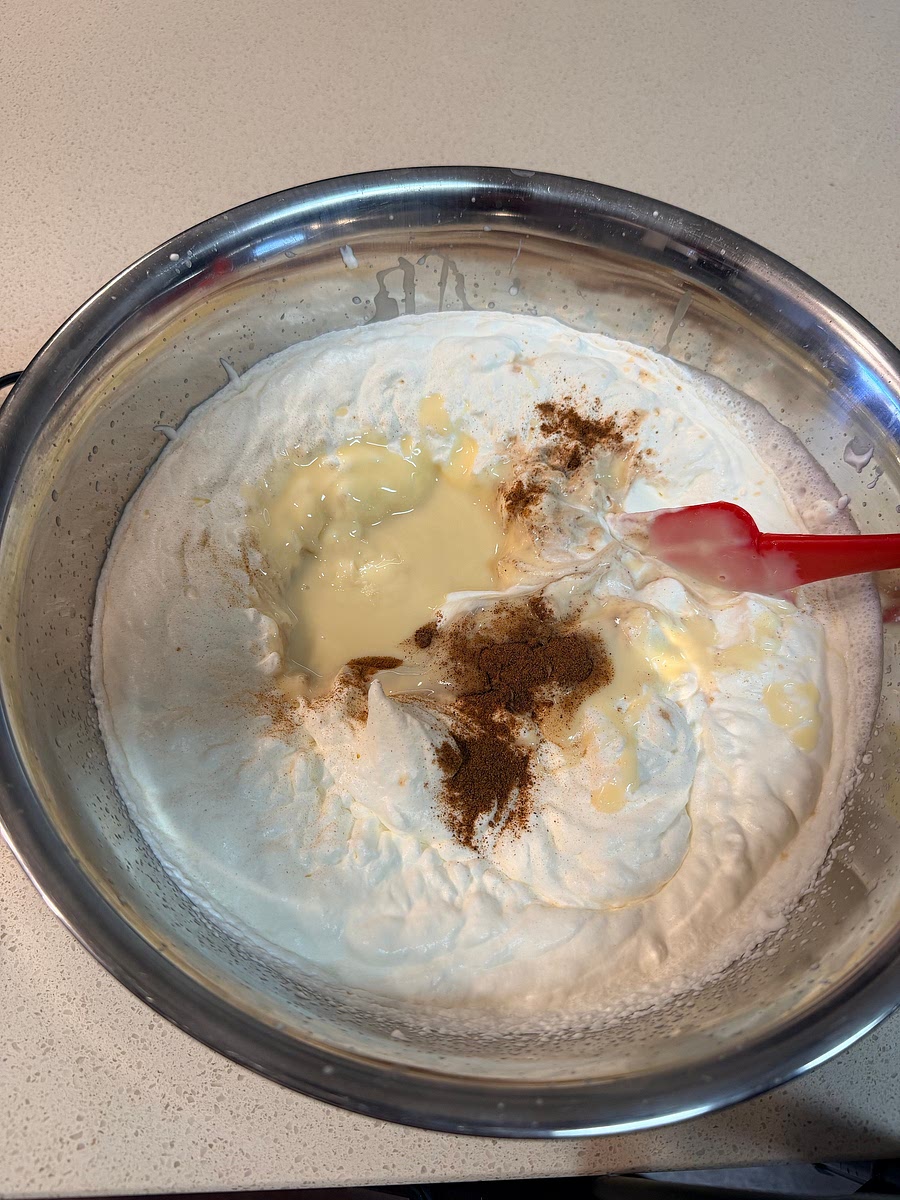 Fold in the sweetened condensed milk, vanilla extract, nutmeg, and cinnamon until well combined.
