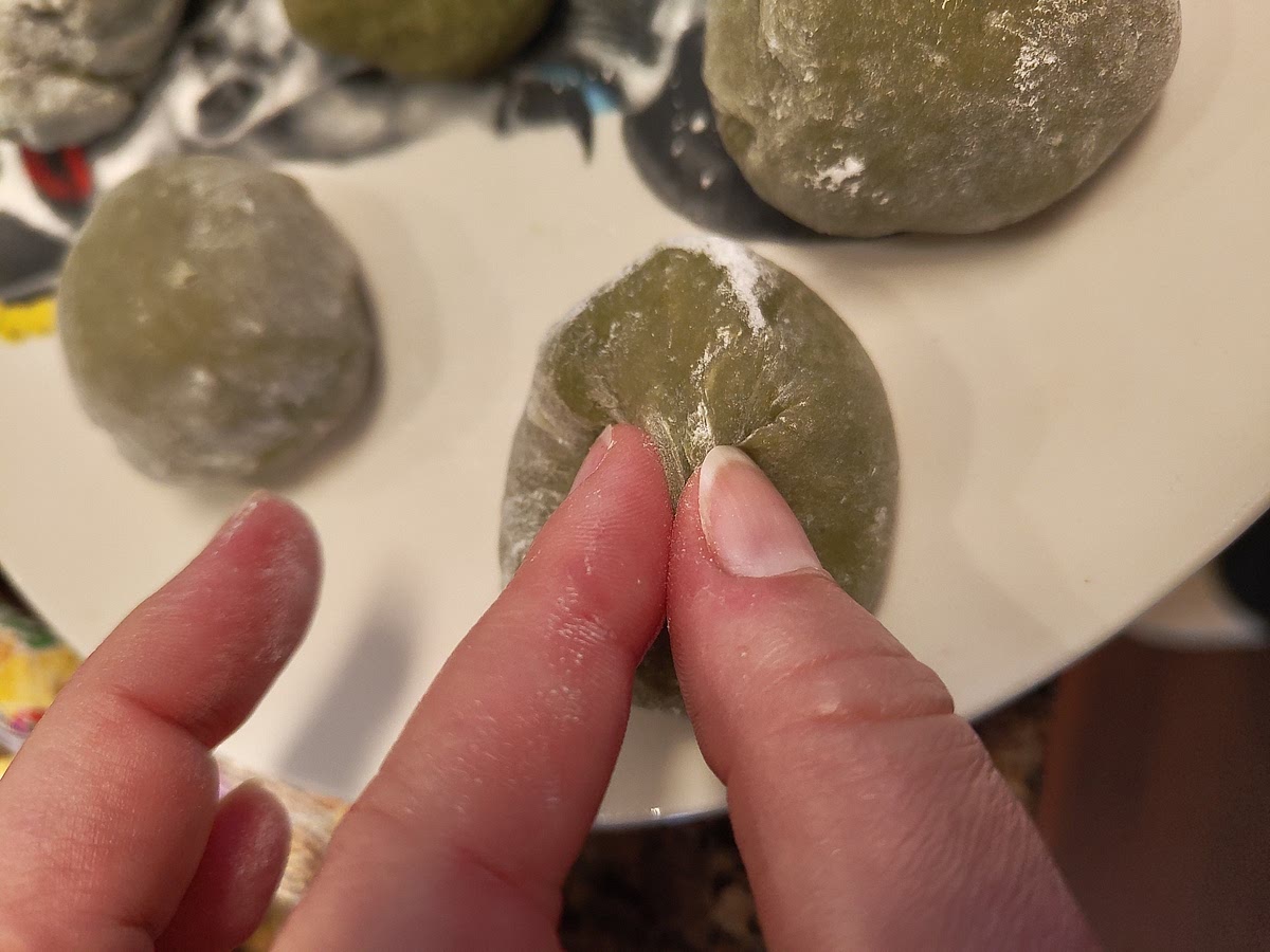 Use ample starch. Corn or potato flour. Probably others will work too. Put small portions in batches on there. Make your hands starchy and roll the mochi into balls. Pinch together to make a taught ball. Wipe off extra starch before eating. Itadakimasu! Recommend to have with tea.