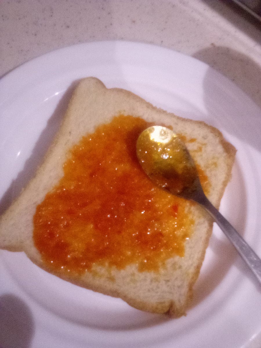 Put sauce on your bread. This looks like jam, but it's actually the sauce my father made this evening. I put just a bit because it's spicy, but your sauce probably isn't so feel free to coat you slice in yours! πΆοΈπ₯«π