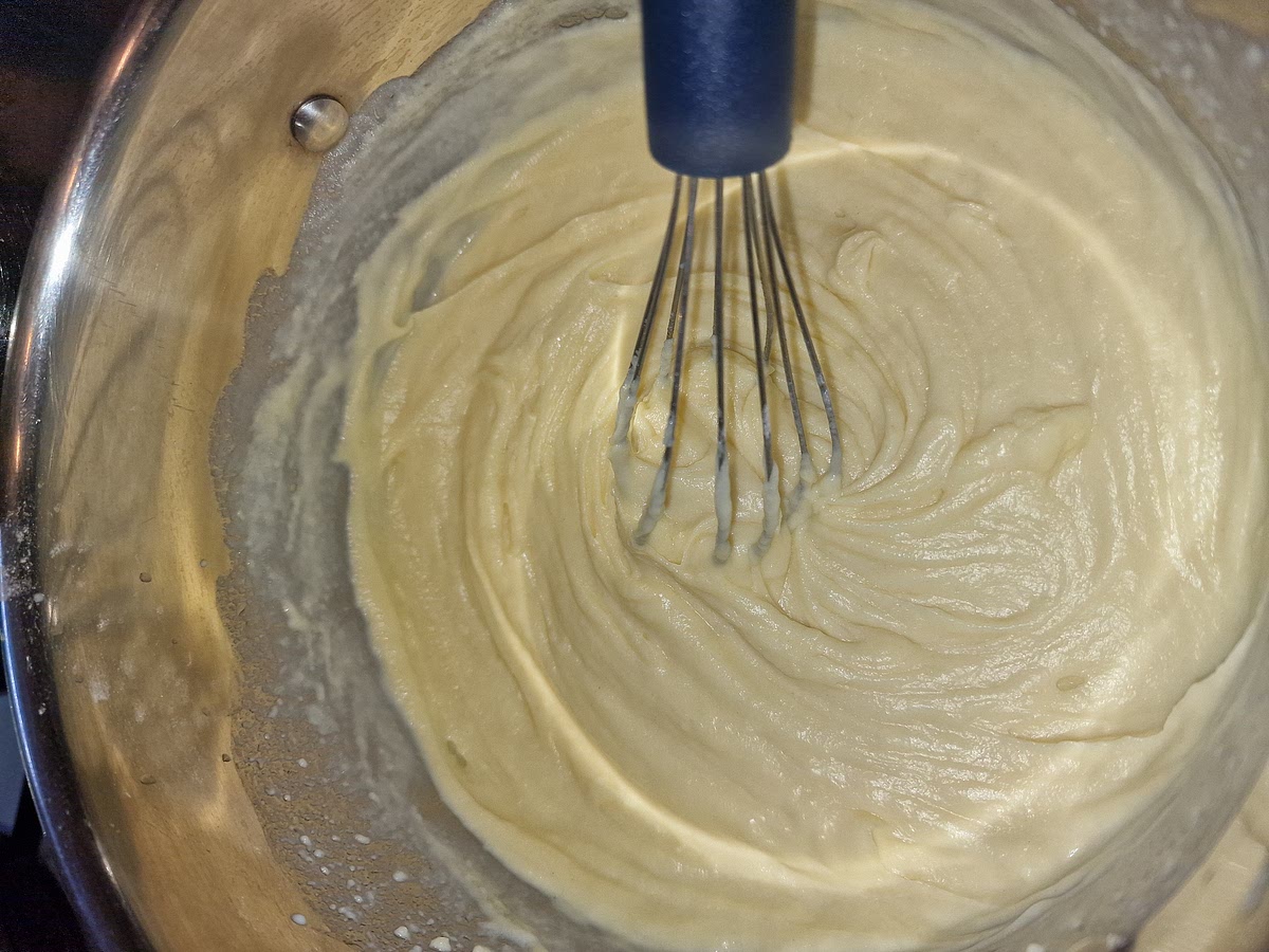 After your butter and flour thickens completely, start adding milk bit by bit while stirring continually. Still on low heat. Eventually you'll get a fairly thick sauce. From now on just keep stirring and adding milk bit by bit until you have your desored amount and thickness.