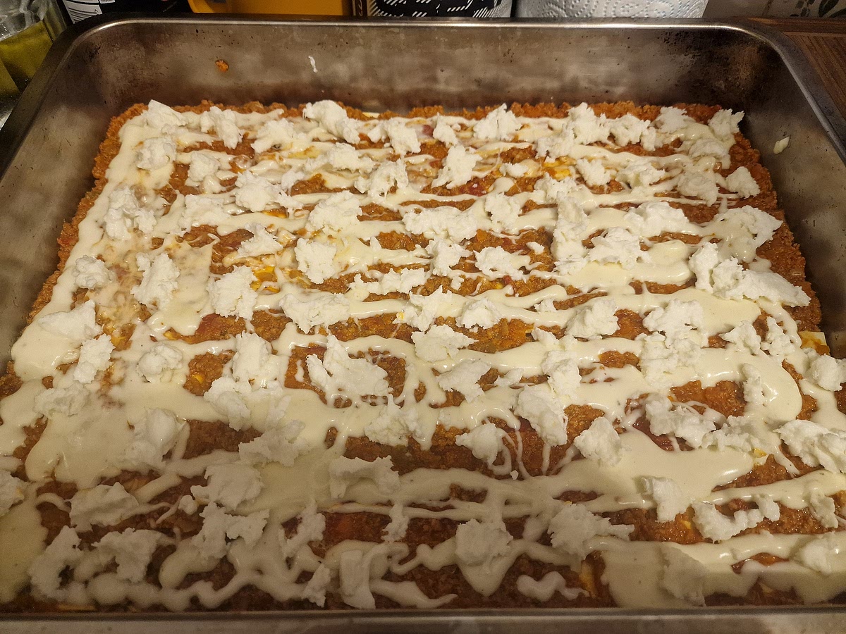 It's time to construct your lasagne. It is still a pasta dish so we don't want the meat layers to be too thick otherwise it won't hold shape and there won't be enough pasta. Grate your parmesan in advance.