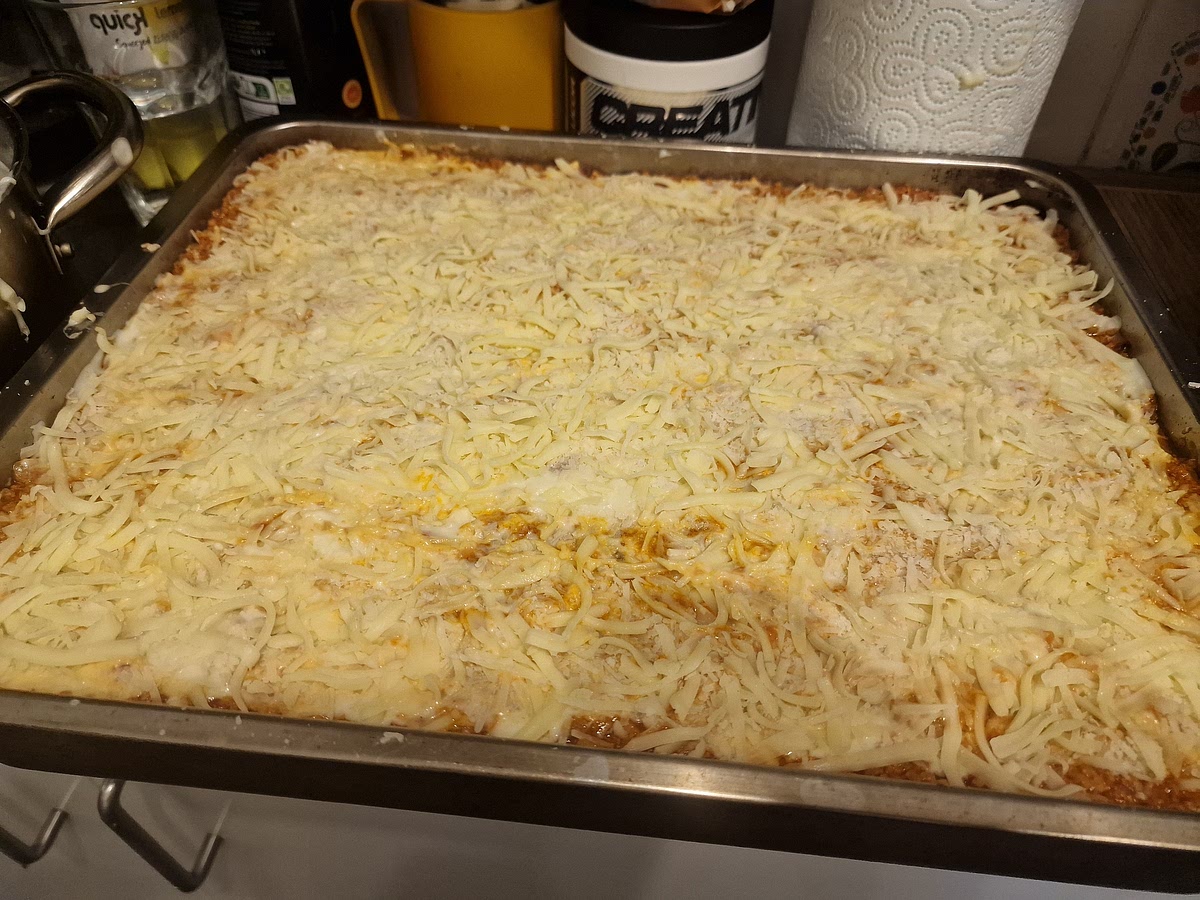 Constructing order: it is very important that you start with a thin layer of bolognese first so that your lasagne doesn't stick to the tray. My order is this:
- thin layer of meat
- layer of lasagne sheets (they can overlap a bit)
- thin layer of meat
- thin layer of bechamel sauce
- evenly spread fresh mozzarella (I tear off small chunks with my hands and place them around)
- thin layer of grated parmesan (literally just dust it with the grated cheese)
- layer of lasagne sheets
- thin layer of meat... And repeat until you get to the top or run out of ingredients. The important part is to not use too much meat in the layering. Make really just a thin layer, you should still see a bit of sheet underneath the meat in a few spots and that's fine so don't worry.