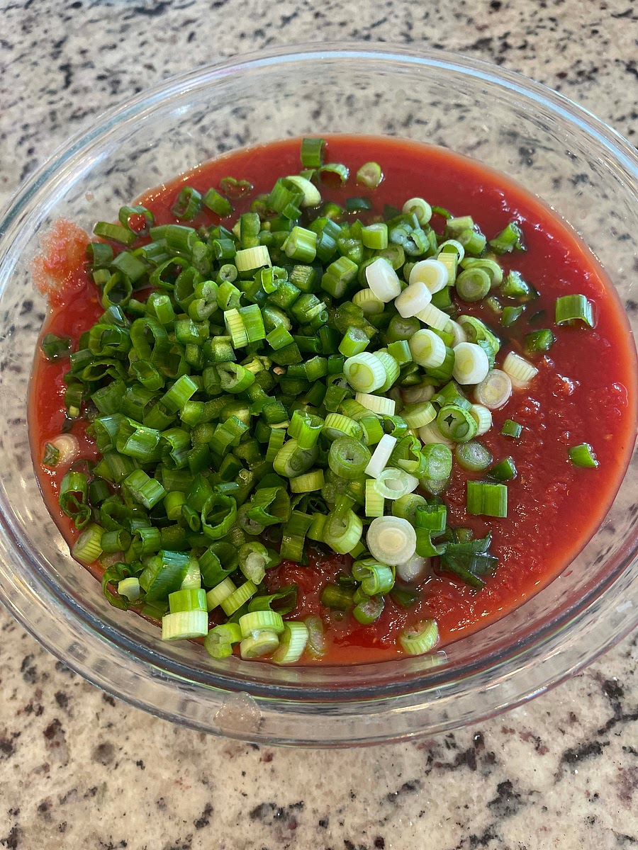 Finely chop your green onions and add them to the bowl.