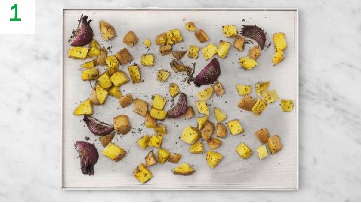 Preheat your oven to 220°C/200°C fan/gas mark 7.
Chop the potatoes into 1cm chunks (no need to peel).
Halve and peel the red onion, then cut each half into 3 wedges.
Pop both veg onto a large baking tray. Drizzle with oil, sprinkle over half the roasted spice and herb blend, season with salt and pepper, then toss to coat. Spread out in a single layer.