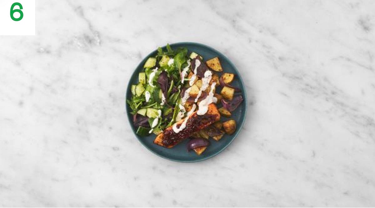 Transfer your salmon and sticky veg to your serving plates. Serve with the salad alongside.
Drizzle over the garlic yogurt to finish.