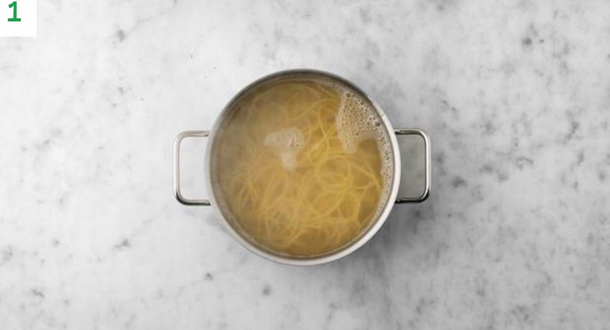 Boil a full kettle. Pour it into a saucepan with 1/2 tsp salt on high heat.
Boil the pasta, 8 mins.
Once cooked, drain and pop back in the pan. Drizzle with oil and stir through.