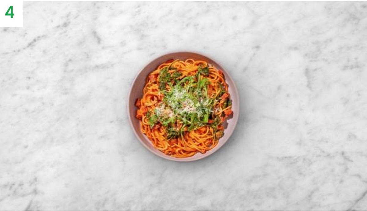 Stir the cooked pasta, sun-dried tomato paste and half the cheese into the sauce. Add a splash of water if needed.
Share between bowls.
Sprinkle over the remaining cheese and chilli.