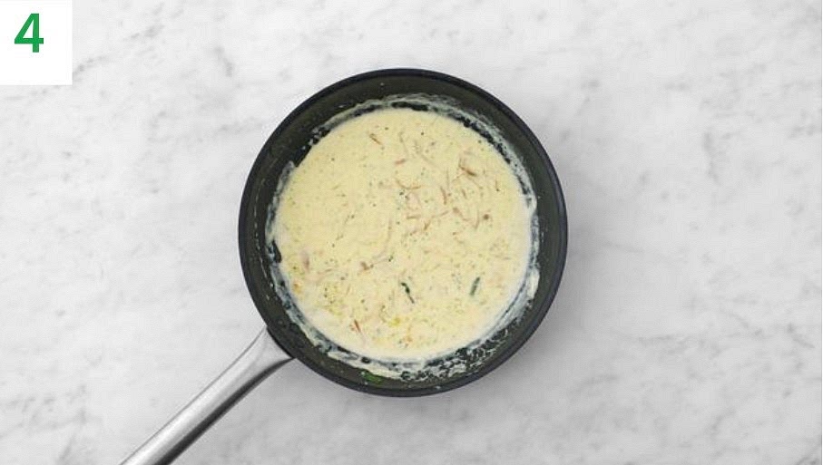 Put your (now empty) frying pan back on the medium heat with a drizzle of oil. Once hot, add the shallot and cook, stirring occasionally, until softened, 4-5 mins. Stir in the veg stock paste and reserved pasta water, then simmer until reduced by half, 3-4 mins.
Mix in the crème fraiche and heat through until piping hot, then season with pepper.