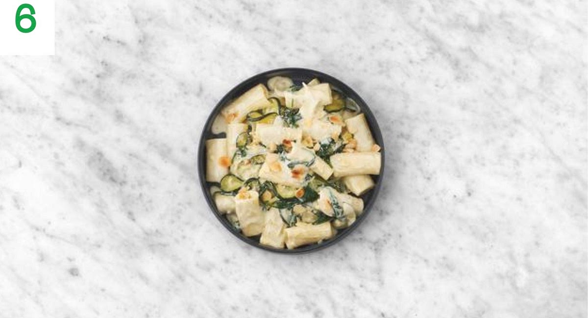 Share the creamy pasta between your bowls.
Sprinkle over the remaining hard italian style cheese and flaked almonds to finish.