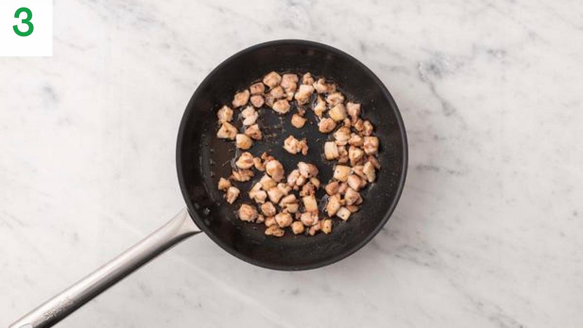 Heat a drizzle of oil in a large pan on medium-high heat.
Once hot, add the diced chicken and season with salt and pepper.
Fry until golden brown on the outside, 5-6 mins.