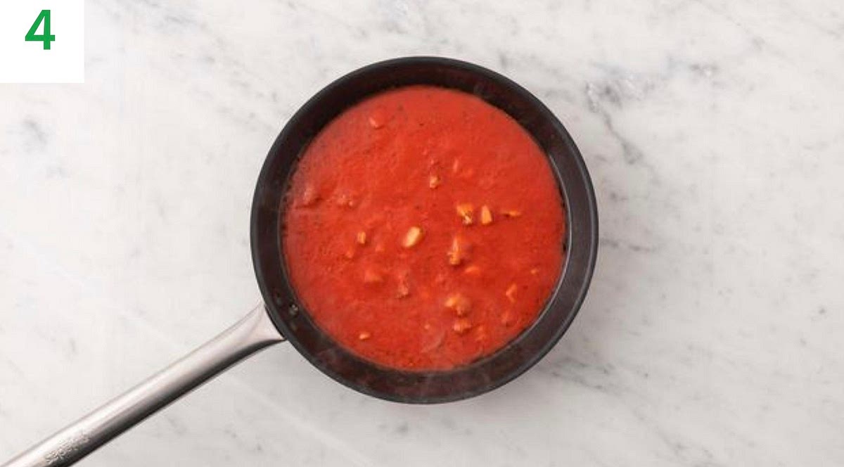 Add the garlic and Cajun spice mix to the chicken. Cook, stirring frequently, for 1 min.
Stir in the passata, sugar and water for the sauce and the chicken stock paste.
Bring to the boil, until thickened, 5-6 mins.