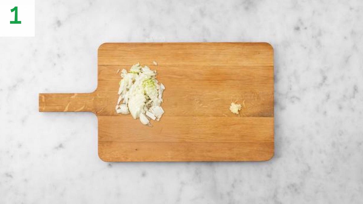 Preheat your oven to 220°C/200°C fan/ gas mark 7. Boil a full kettle.
Halve, peel and thinly slice the onion.
Peel and grate the garlic.
Drain the sweetcorn in a sieve.