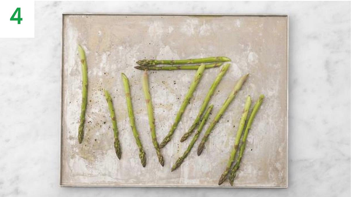 When 12 mins off risotto cooking time remain, pop the asparagus onto a baking tray.
Drizzle with oil, season with salt and pepper, then toss to coat. Spread out in a single layer.
Roast on the bottom shelf until tender, 11-13 mins.