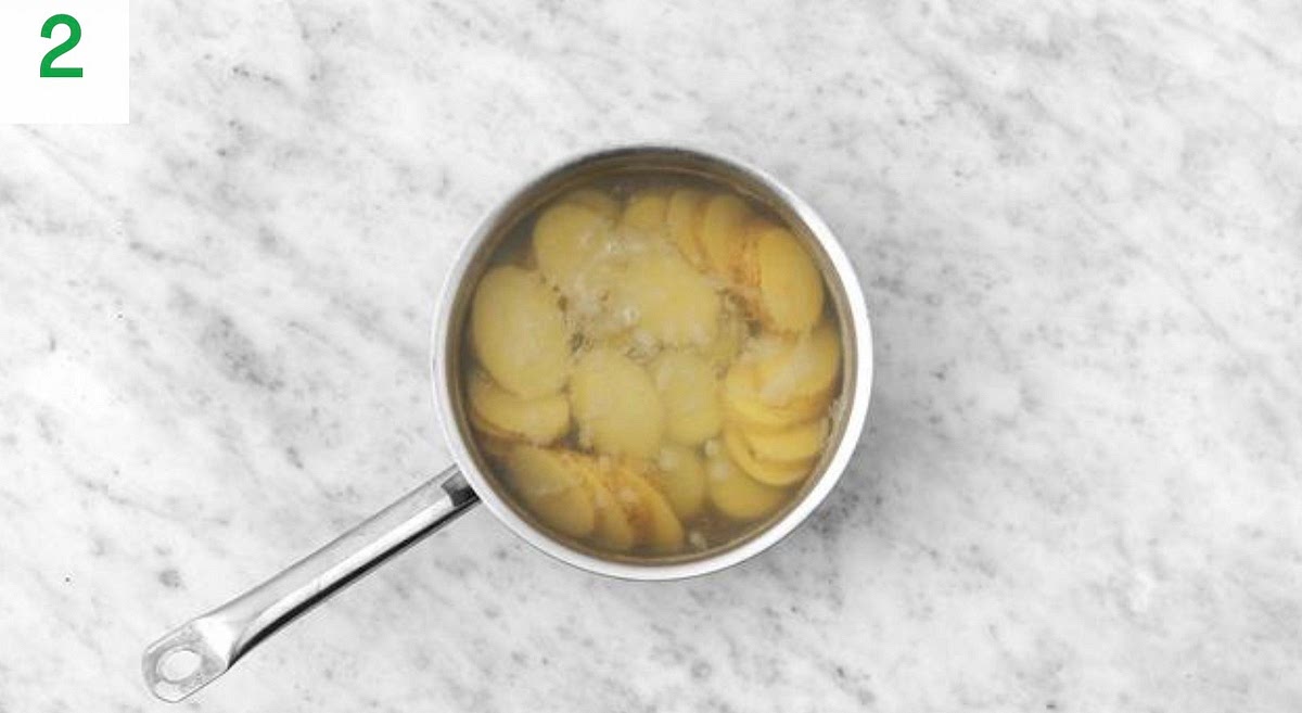 Once boiling, add the potato slices to the water and simmer until just tender, 8-12 mins. Once cooked, carefully drain in a colander.
Meanwhile, halve any thick broccoli stems lengthways and pop onto a large baking tray. Drizzle with oil, season with salt and pepper, then toss to coat.
Add the tomatoes to the other side of the tray. Drizzle with oil, season with salt and pepper, then toss to coat. Set aside for now.