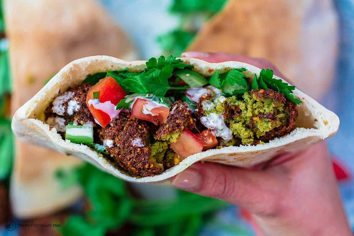 Serve falafel hot next to other small plates; or assemble the falafel patties in pita bread with tahini or hummus, arugula, tomato and cucumbers. Enjoy!