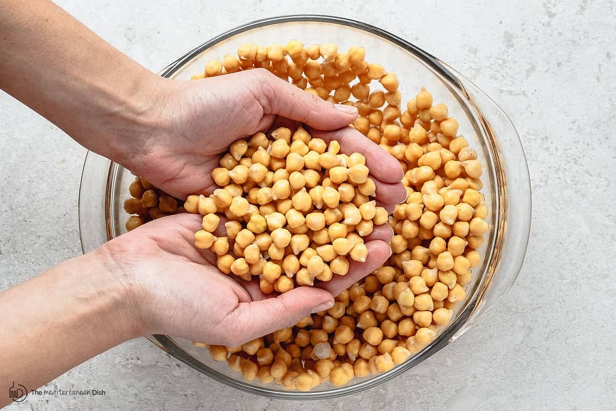 (One day in advance) Place the dried chickpeas and baking soda in a large bowl filled with water to cover the chickpeas by at least 2 inches. Soak overnight for 18 hours (longer if the chickpeas are still too hard). When ready, drain the chickpeas completely and pat them dry.