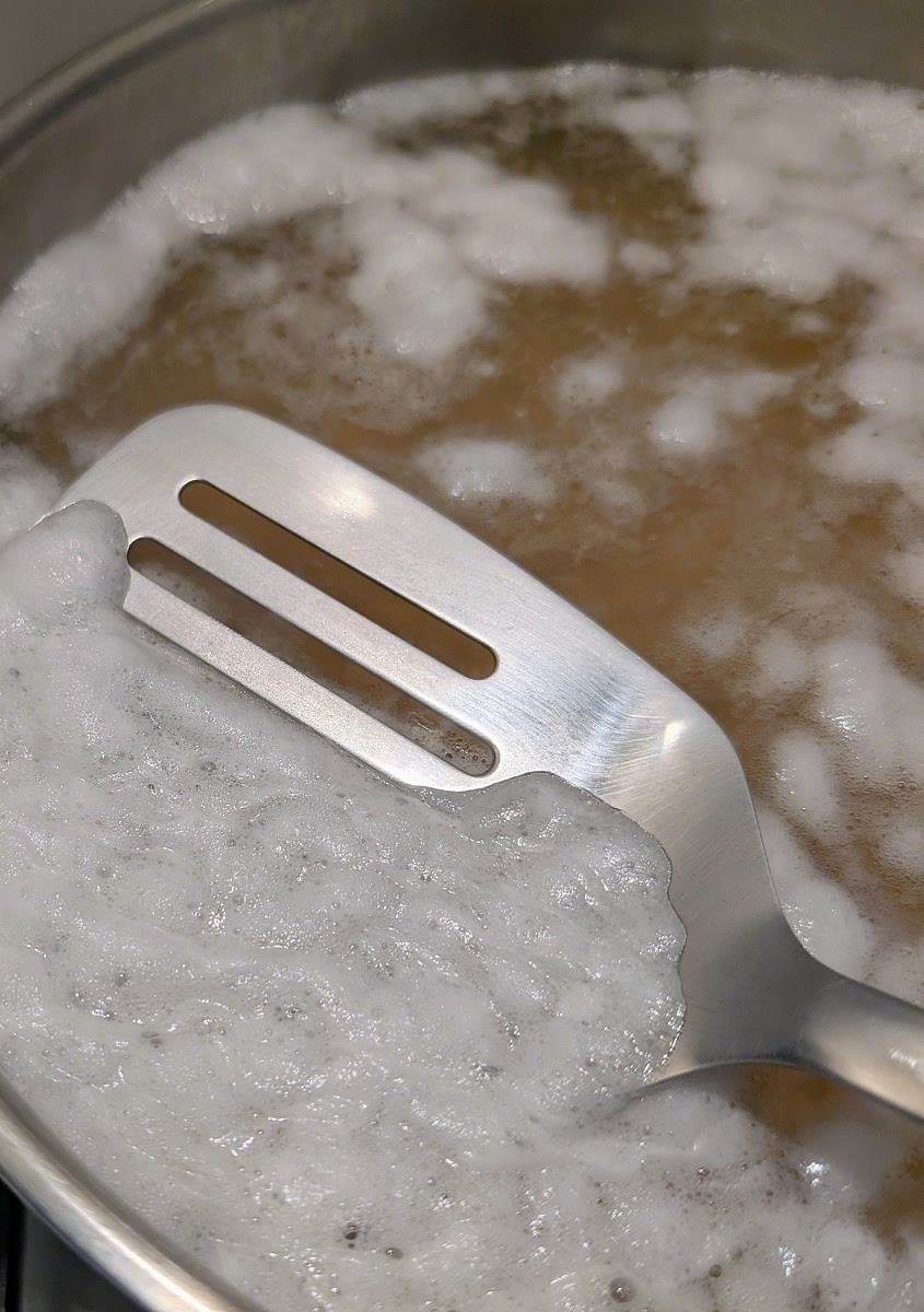 Once the chickpeas have simmered for 1 hour, uncover, pick out any remaining surface foam, reduce heat to low, add 2tbsp of vegetable oil, add the sofritto, the freshly ground cumin, the bay leaves and the liquid smoke, season with msg, salt and pepper and stir to dissolve it all and mix it in. If necessary, add water to just above the chickpea level and simmer for 10 minutes.