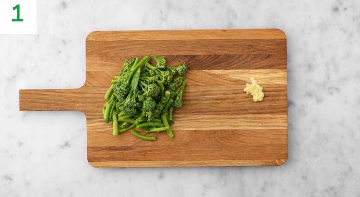 Preheat your oven to 220°C/200°C fan/gas mark 7.
Peel and grate the garlic (or use a garlic press). Cut the Tenderstem® broccoli into thirds.
Heat a drizzle of oil in a large saucepan on medium-high heat.
Once hot, add half the garlic. Cook for 30 secs.