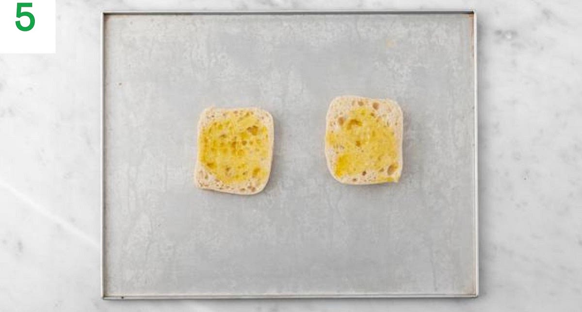 Switch your oven to grill on high heat and grill your moussaka until the cheese is golden and bubbling, 5-6 mins.
Grill the garlic ciabatta alongside until golden and toasted, 2-3 mins.
Meanwhile, when your pan of water is boiling, add the broccoli and cook until just tender, 3-4 mins.
Once cooked, drain in a colander, then return to the pan. Drizzle with a little oil and season with salt and pepper.