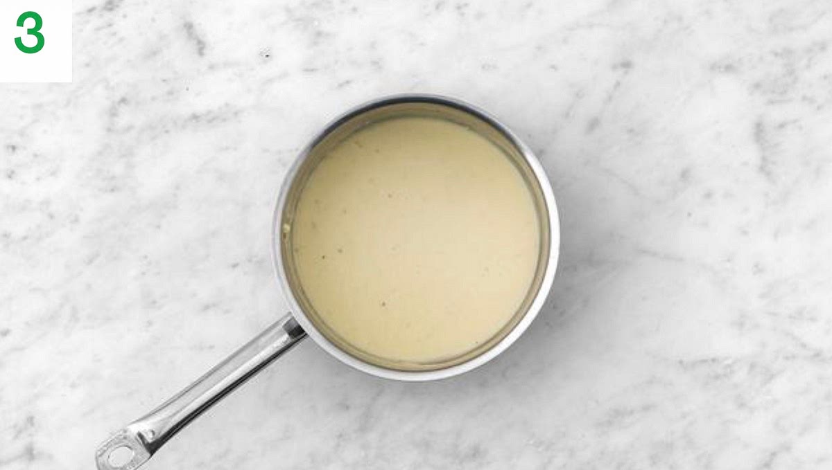 Gradually stir in the water for the sauce, then stir in the creme fraiche and half the cheese.
Lower the heat, then simmer until the sauce has thickened and the cheese has melted, 1-2 mins.
Season with salt and pepper. Add a splash of water if it's a little too thick.