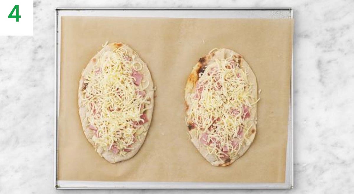 Pop the naans onto a baking tray.
Divide the cheesy sauce between them and spread with the back of a spoon, leaving a 1cm border.
Top with the sliced ham, then sprinkle over the remaining cheese.