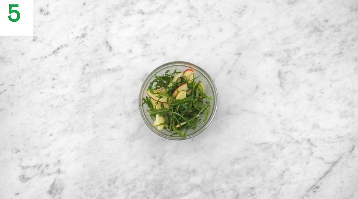 When the oven is hot, bake on the top shelf until the cheese is golden and bubbling, 6-7 mins.
Meanwhile, quarter, core and thinly slice the apple (no need to peel).
In a medium bowl, combine the cider vinegar, sugar and olive oil for the dressing (see pantry for both amounts).
Season with salt and pepper.
Just before everything's ready, add the baby leaves and apple to the dressing and toss. TIP: Don' t add the leaves too early or they ' ll go soggy.