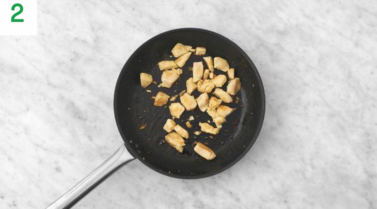 Meanwhile, heat a drizzle of oil in a large frying pan on medium-high heat.
Once hot, add the diced chicken and season with salt and pepper. Fry until golden brown on the outside and cooked through, 8-10 mins.