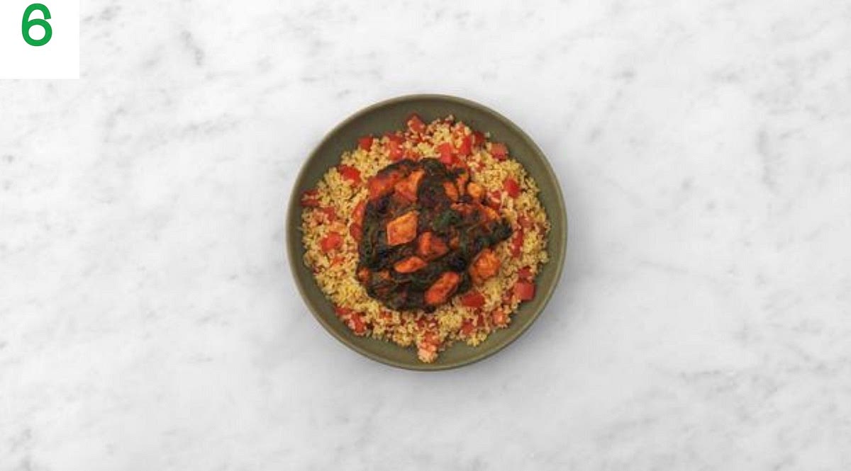Share the bulgur between your bowls.
Spoon the harissa cranberry chicken over the top.