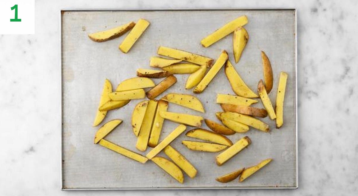 Preheat your oven to 220°C/200 °C fan/gas mark 7.
Chop the potatoes lengthways into 1cm slices, then chop into 1cm wide chips (no need to peel).
Pop the chips onto a large baking tray. Drizzle with oil, season with salt and pepper, then toss to coat. Spread out in a single layer. TIP: Use two baking trays if necessary. When the oven is hot, bake on the top shelf until golden, 25-30 mins. Turn halfway through.