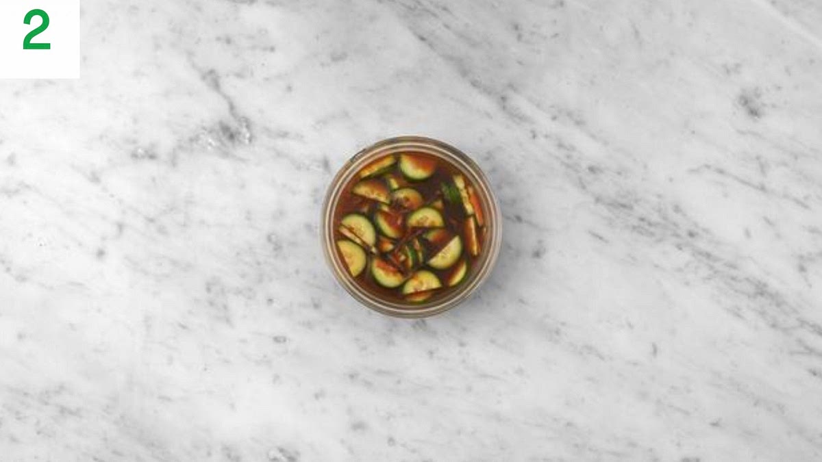 Meanwhile, trim the cucumber, then halve lengthways.
Thinly slice widthways. Trim the carrot, then coarsely grate (no need to peel).
In a medium bowl, combine the soy sauce, rice vinegar, a third of the gochujang paste, half the ginger puree and the sugar for the pickle (see pantry for amount).
Add the carrot and cucumber to the dressing. Mix together well, then set aside to pickle.