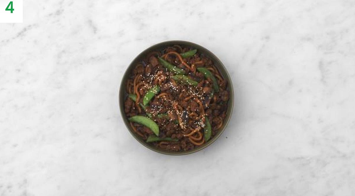 Share your noodles between your serving bowls.
Sprinkle over the sesame seeds to finish.