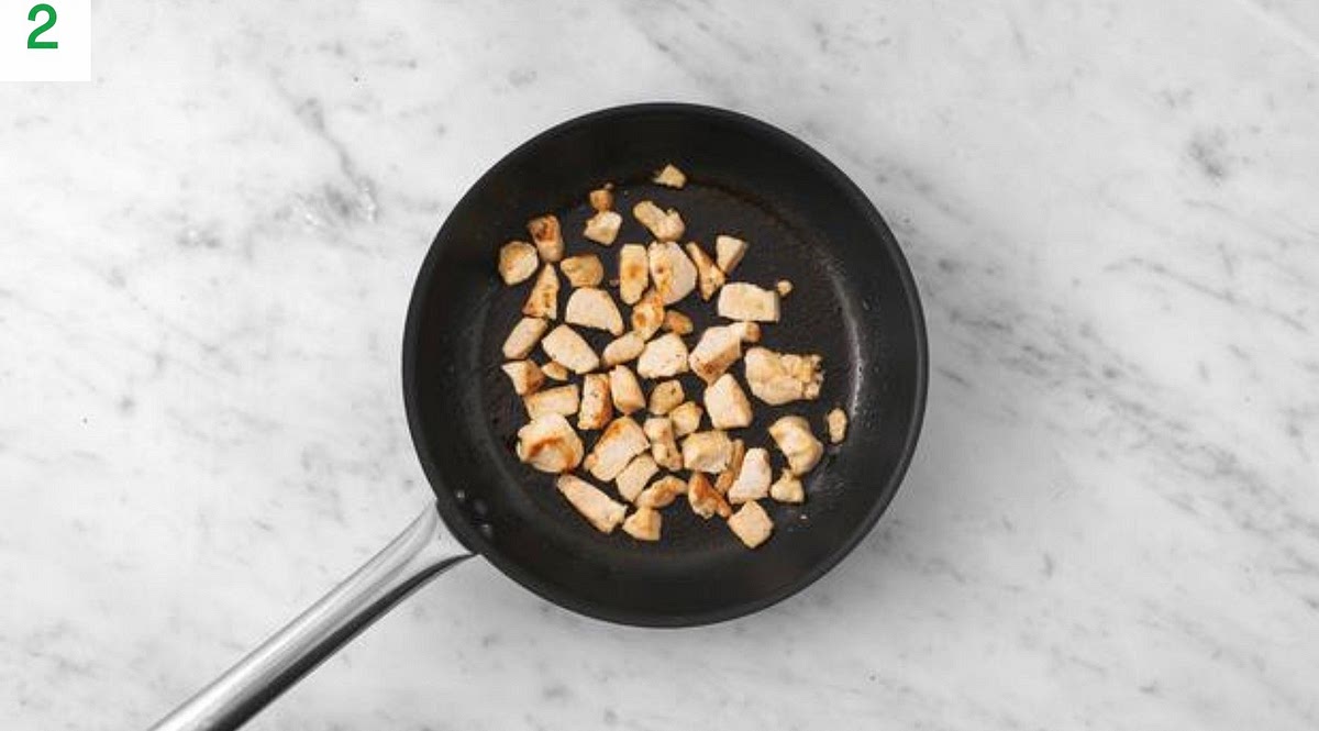 Next, heat a drizzle of oil in a frying pan on medium high heat.
Once hot, fry the chicken and sliced mushrooms, 8-10 mins. Season with salt and pepper. Once cooked, add the pea pods to the chicken. Fry, 2 mins more.
Meanwhile, cut the lime into wedges.