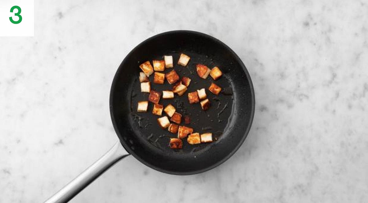 Heat the remaining oil for cooking in a large frying pan on medium-high heat.
Once hot, add the paneer and fry until golden all over, 5-8 mins. Season with salt and pepper. Turn regularly to brown it evenly.
Once the paneer is golden, transfer to a plate lined with kitchen paper.