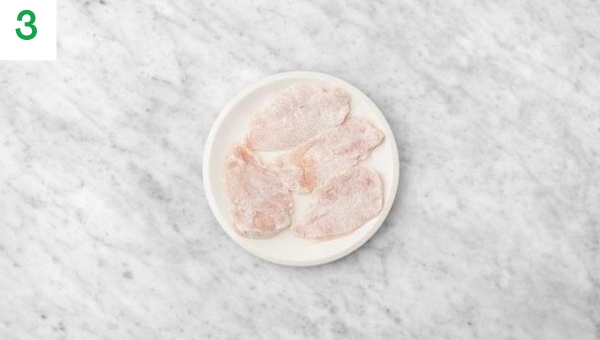 Put the flour (see pantry for amount) in a bowl with a good pinch of salt and some pepper and mix together.
Lay your chicken breast in the bowl, then toss to ensure the chicken gets an even coating of flour. Repeat for the other breast(s).