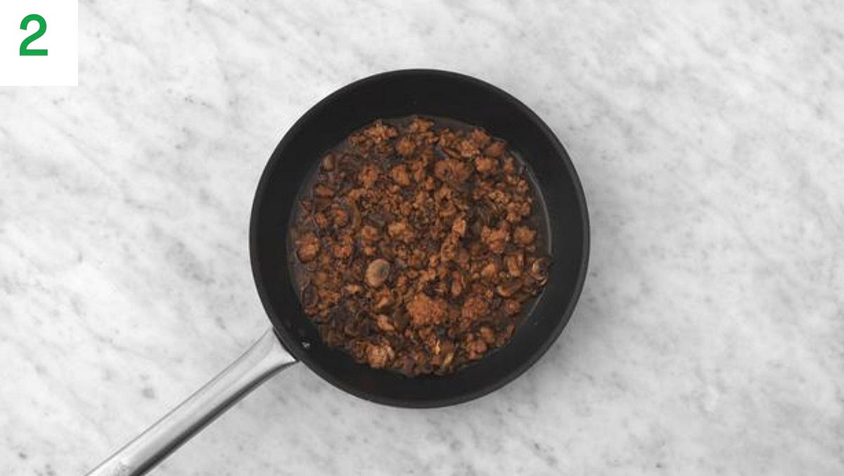 Once the beef mince has browned, add the garlic and ginger puree. Fry until fragrant, 1-2 mins.
When fragrant, add the soy, chicken stock paste, hoisin sauce, sugar and water for the sauce (see pantry for both amounts).
Bring to a boil, then lower the heat to a very gentle simmer and leave to braise until thickened and tender,15-20 mins.