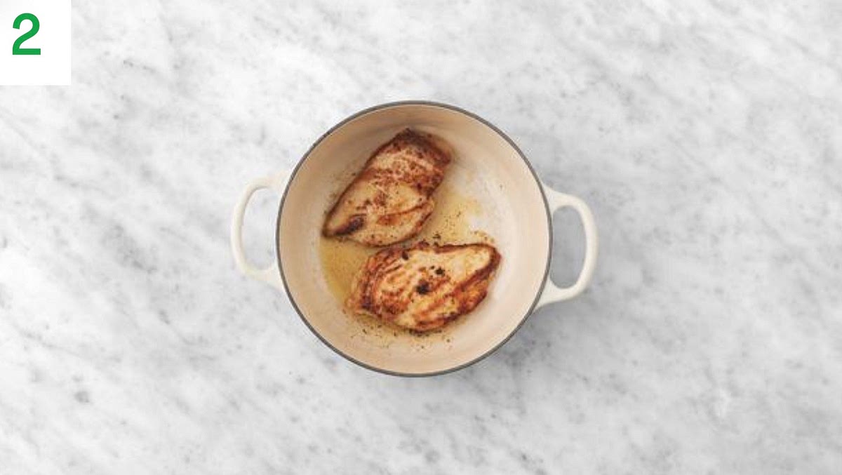 Heat a drizzle of oil in a large, wide-bottomed ovenproof pan on medium-high heat. TIP: If you don't have an ovenproof pan, use a normal pan and transfer to an ovenproof dish before baking. Once hot, lay the chicken into the pan and cook until browned, 5 mins each side. Once browned, remove the chicken from the pan and set aside on a clean plate (you'll finish cooking it later).