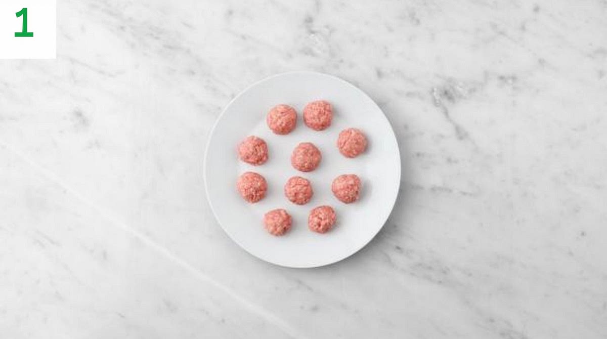 Preheat your oven to 220°C/200°C fan/gas mark 7. Bring a large saucepan of water to the boil with ½ tsp salt for the noodles.
Peel and grate the garlic (or use a garlic press).
In a large bowl, combine the ginger puree, breadcrumbs, half the garlic and the salt and water for the breadcrumbs (see pantry for both amounts), then add the pork mince.
Season with pepper and mix together with your hands. Roll into evenly-sized balls, 5 per person.