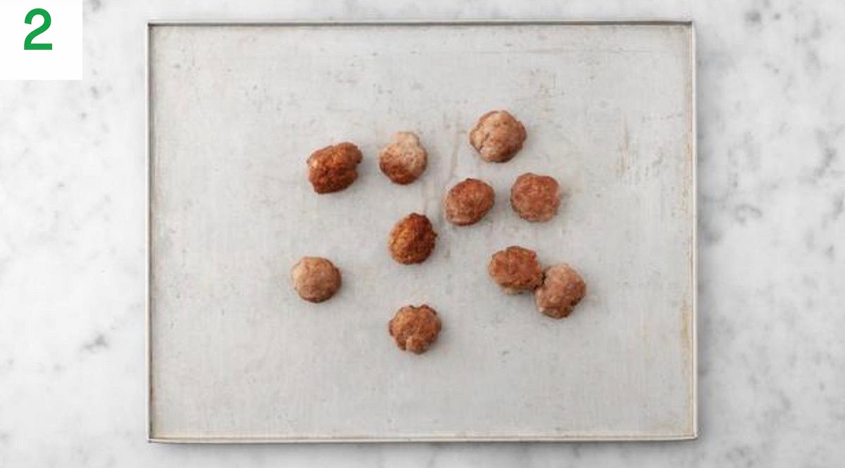 Pop the meatballs onto a large baking tray.
When the oven is hot, bake on the top shelf until browned on the outside and cooked through, 12-15 mins.
