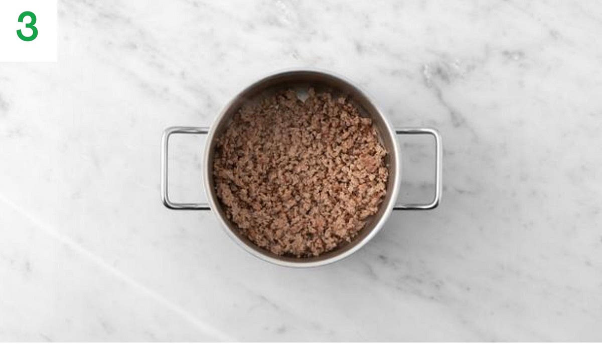 Meanwhile, heat a drizzle of oil in a wide- bottomed
saucepan (with a lid) on medium-high heat.
Once hot, add the beef mince and chorizo and fry until browned, 2-3 mins. Use a spoon to break it up as it
cooks. Once browned, drain and discard any excess fat. Season with salt and pepper.