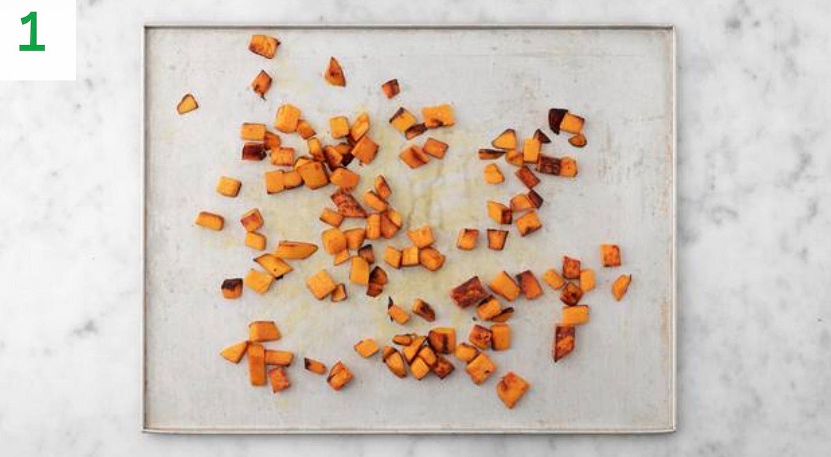 Preheat your oven to 220°C/200°C fan/gas mark 7. Chop the sweet potato into 2cm chunks (no need to peel).
Pop the diced sweet potato onto a large baking tray.
Drizzle with oil, season with salt and pepper, then toss to coat. Spread out in a single layer. TIP: Use two baking trays if necessary.
When the oven is hot, roast on the top shelf until golden and tender, 25-35 mins. Turn halfway through.