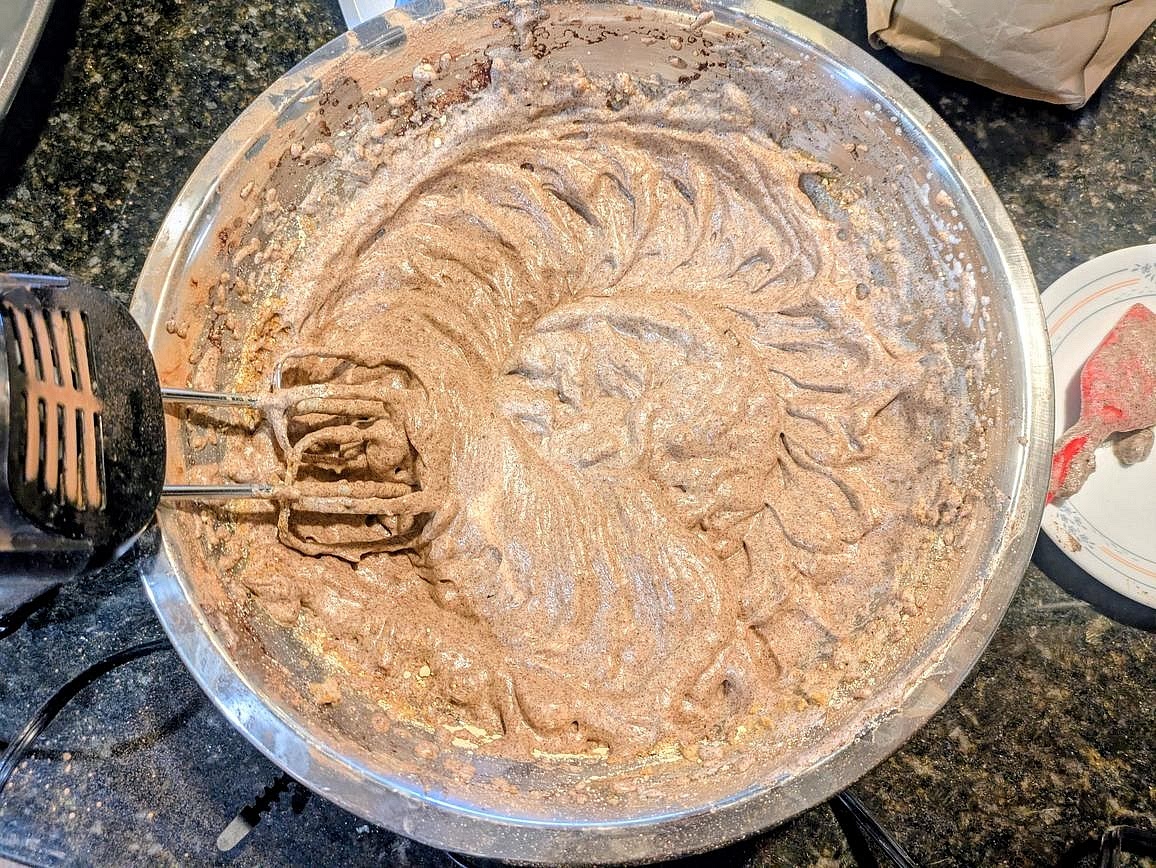 Lightly fold in the carob powder and powdered peanut butter, trying to deflate the mixture as little as possible