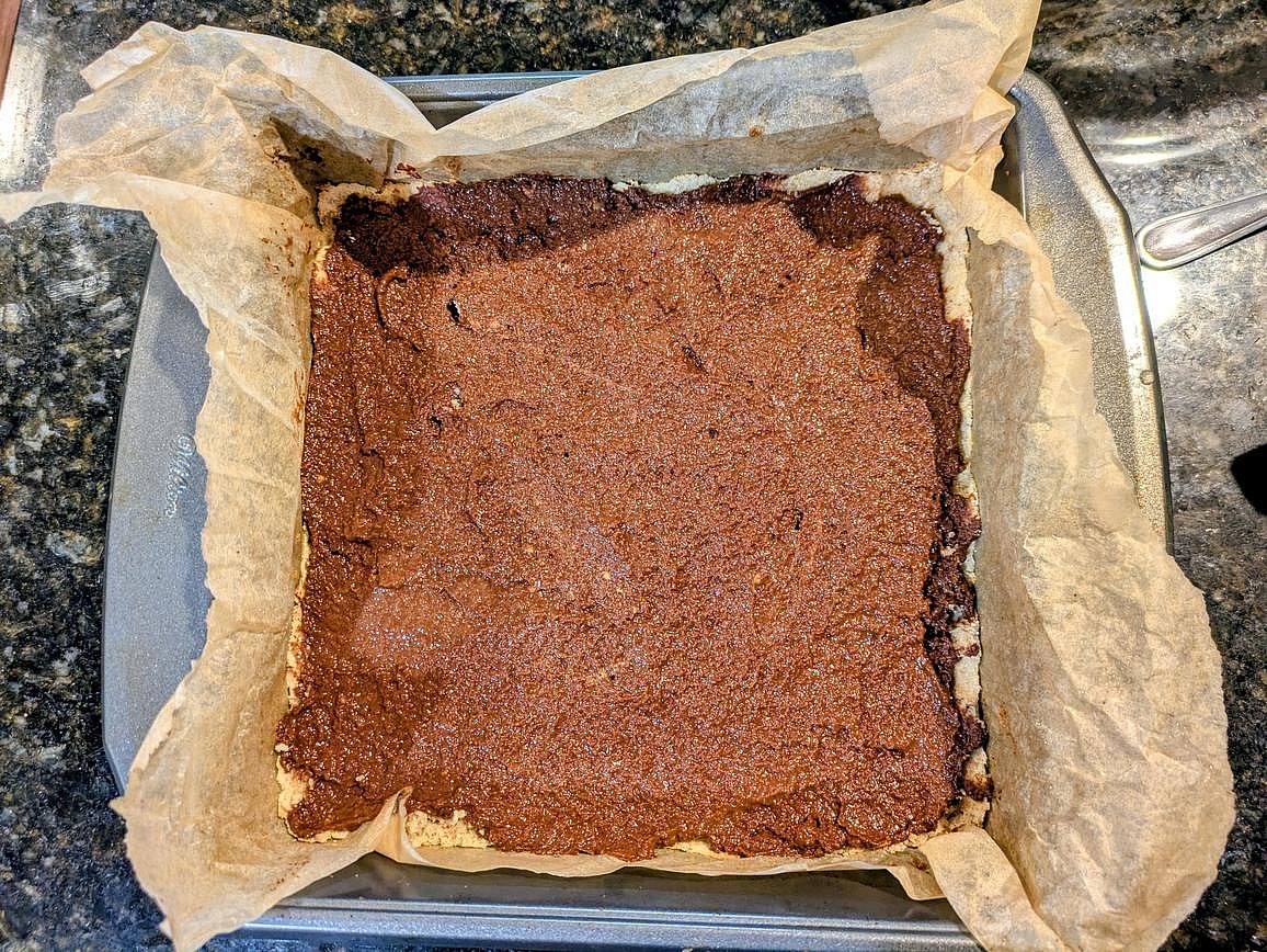 Add the chocolate spread onto the cooled crust. Lightly wetting the back of a spoon to spread it helps prevent sticking and tearing