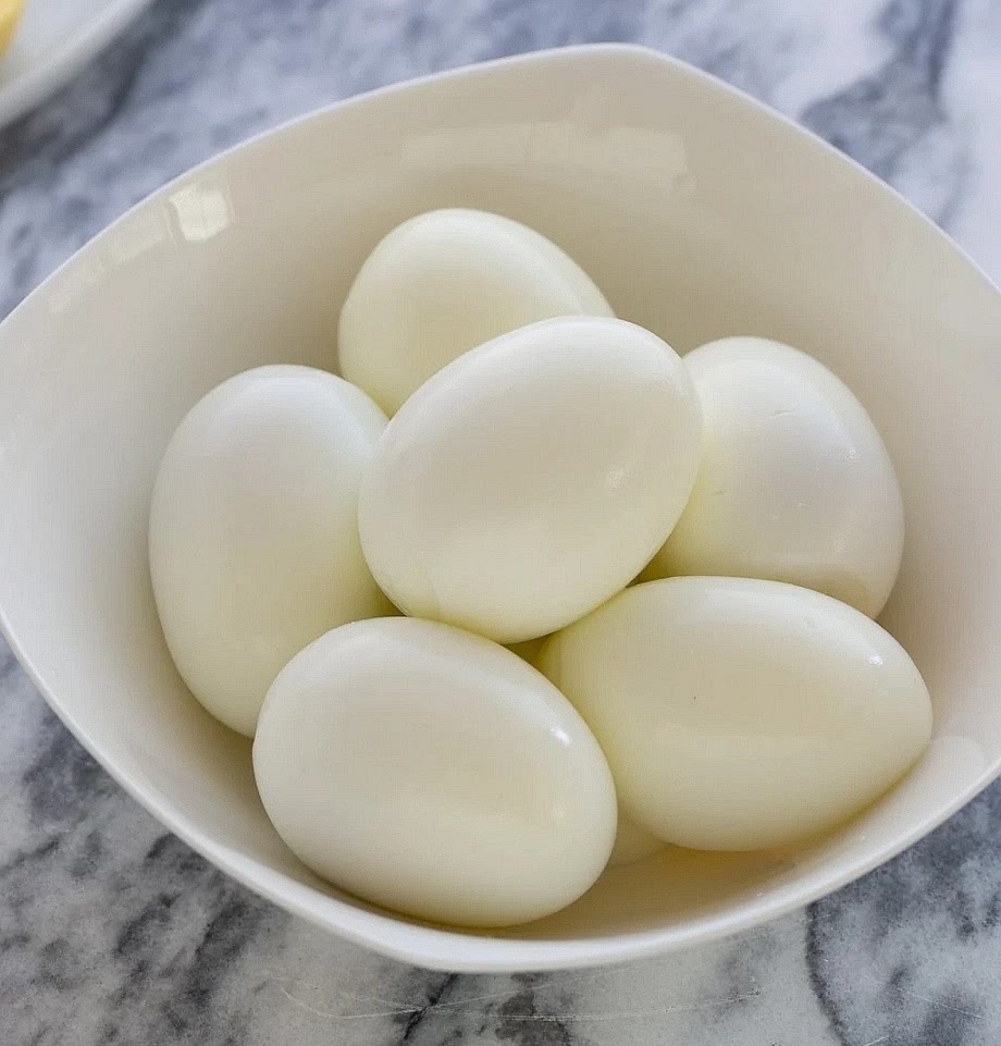 Prepare the Eggs: Hard-boil a carton of eggs, cool them in an ice bath, and peel them.