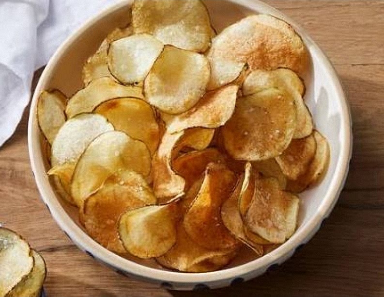Select the Base: Open a bag of kettle-cooked potato chips to use as the edible "spoon" for the toppings.